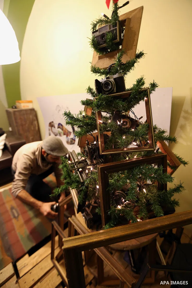 Palestinian Photographer, Elias Halabi, decorates a Christmas tree with cameras old at his house in the West Bank city of Bethlehem December 29, 2014. Photo by Muhesen Amren
