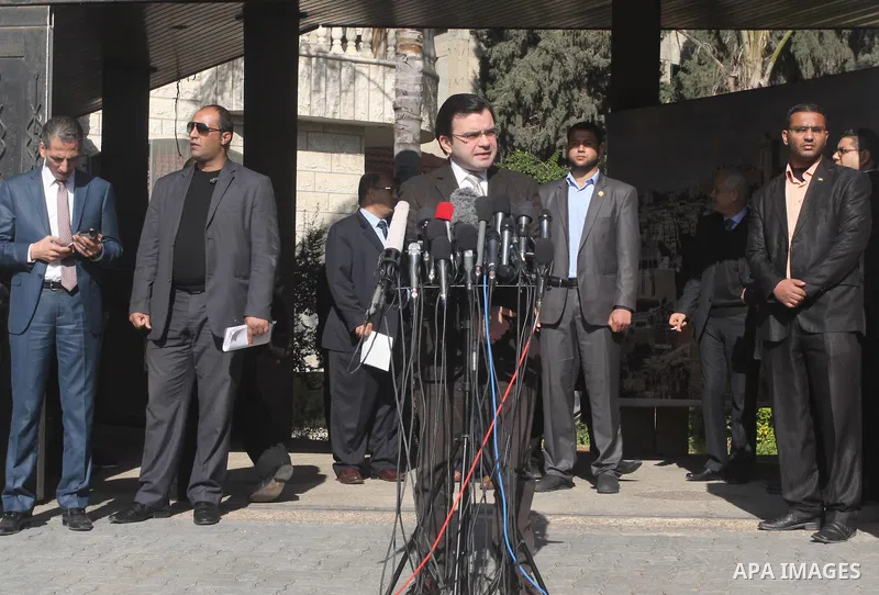 Spokesman of Palestinian unity government Ehab Bsaiso, speaks during a protest to demanding their salaries, in front of the headquarters of the Council of Ministers in Gaza city, on December 30, 2014. Photo by Mohammed A...
