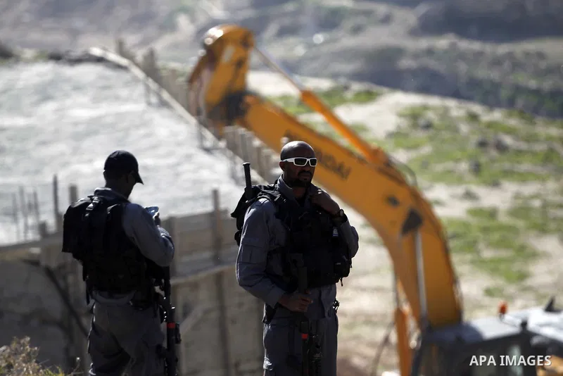 An Israeli bulldozer demolishes a building house at the Jabal al-Mukabbir village in the east of Jerusalem, December 30, 2014. Israeli authorities on Tuesday destroyed three homes, a restaurant, and a butcher shop in Jer...