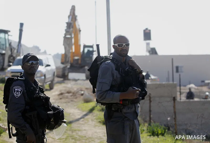 An Israeli bulldozer demolishes a building house at the Jabal al-Mukabbir village in the east of Jerusalem, December 30, 2014. Israeli authorities on Tuesday destroyed three homes, a restaurant, and a butcher shop in Jer...