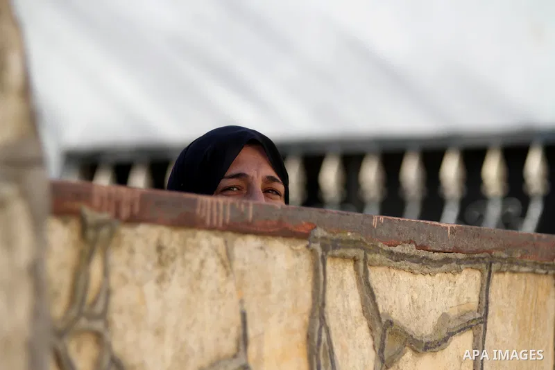 A relative woman of 17-year-old Palestinian teenager Omam Dwekat, who was shot dead by Israeli troops the day before, mourns for him during the funeral in the West Bank village of Baita, near of Nablus, on Dec. 30, 2014....