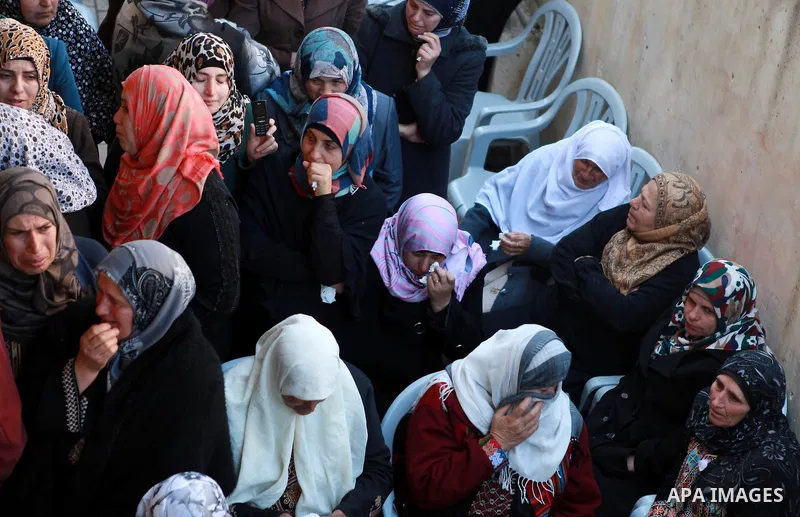 Relatives of 17-year-old Palestinian teenager Omam Dwekat, who was shot dead by Israeli troops the day before, mourn for him during the funeral in the West Bank village of Baita, near of Nablus, on Dec. 30, 2014. Dwekat...