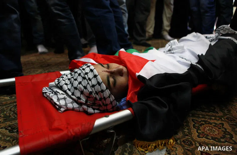 The body of 17-year-old Palestinian teenager Omam Dwekat, who was shot dead by Israeli troops the day before, during his funeral in the West Bank village of Baita, near of Nablus, on Dec. 30, 2014. Dwekat was killed duri...