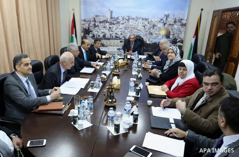 Ministers of the Palestinian unity government at Council of ministers, in Gaza strip attend a meeting in Gaza city, on December 30, 2014. Around 50 Palestinian unity government officials, including eight ministers, arriv...