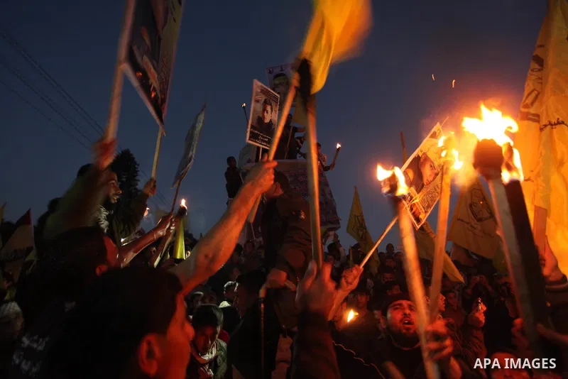 Palestinian Fatah supporter shout slogans during a gathering to celebrate the fiftieth anniversary of the start of the Fatah movement, in Gaza city on December 31, 2014. The Fatah movement was founded by the late iconic...