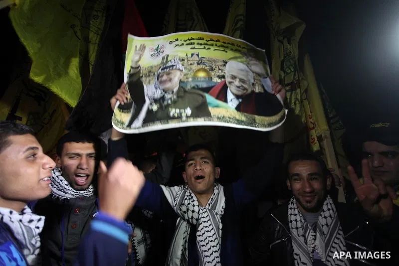 Palestinian Fatah supporter shout slogans during a gathering to celebrate the fiftieth anniversary of the start of the Fatah movement, in Gaza city on December 31, 2014. The Fatah movement was founded by the late iconic...