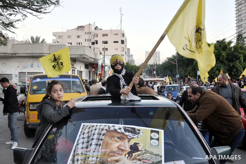Palestinian Fatah supporter shout slogans during a gathering to celebrate the fiftieth anniversary of the start of the Fatah movement, in Gaza city on December 31, 2014. The Fatah movement was founded by the late iconic...
