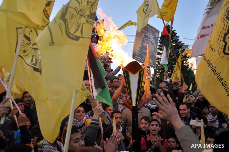 Palestinian Fatah supporter shout slogans during a gathering to celebrate the fiftieth anniversary of the start of the Fatah movement, in Gaza city on December 31, 2014. The Fatah movement was founded by the late iconic...
