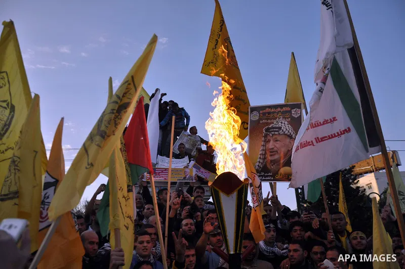 Palestinian Fatah supporter shout slogans during a gathering to celebrate the fiftieth anniversary of the start of the Fatah movement, in Gaza city on December 31, 2014. The Fatah movement was founded by the late iconic...
