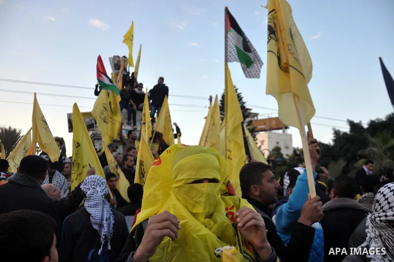 Palestinian Fatah supporter shout slogans during a gathering to celebrate the fiftieth anniversary of the start of the Fatah movement, in Gaza city on December 31, 2014. The Fatah movement was founded by the late iconic...