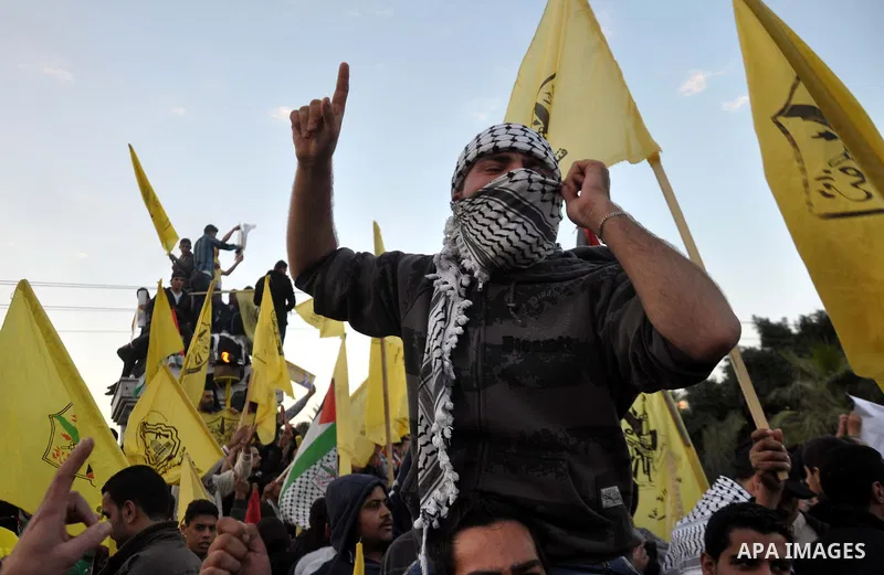 Palestinian Fatah supporter shout slogans during a gathering to celebrate the fiftieth anniversary of the start of the Fatah movement, in Gaza city on December 31, 2014. The Fatah movement was founded by the late iconic...