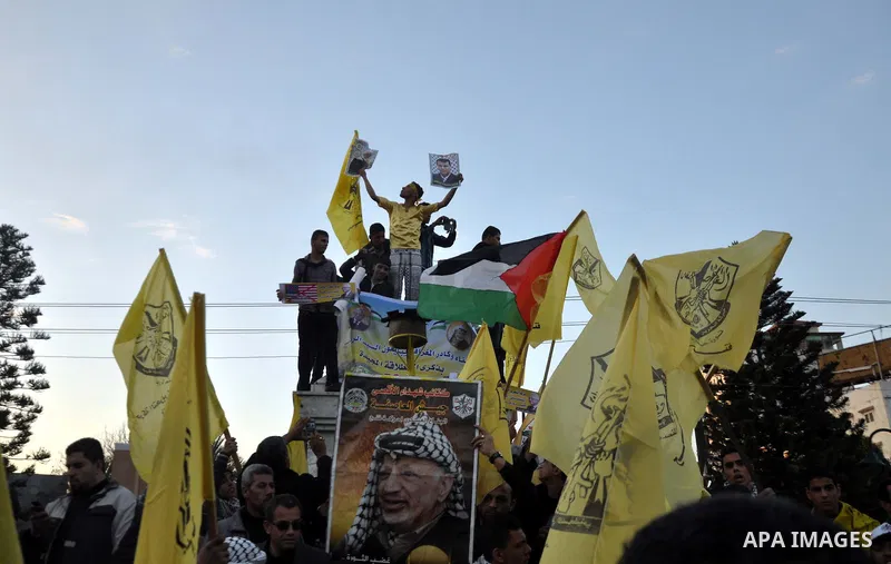 Palestinian Fatah supporter shout slogans during a gathering to celebrate the fiftieth anniversary of the start of the Fatah movement, in Gaza city on December 31, 2014. The Fatah movement was founded by the late iconic...