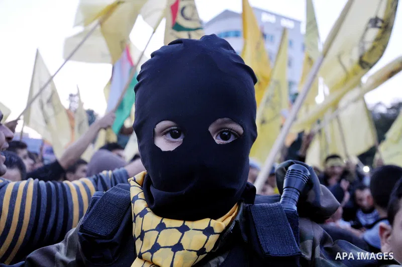 Palestinian Fatah supporter shout slogans during a gathering to celebrate the fiftieth anniversary of the start of the Fatah movement, in Gaza city on December 31, 2014. The Fatah movement was founded by the late iconic...