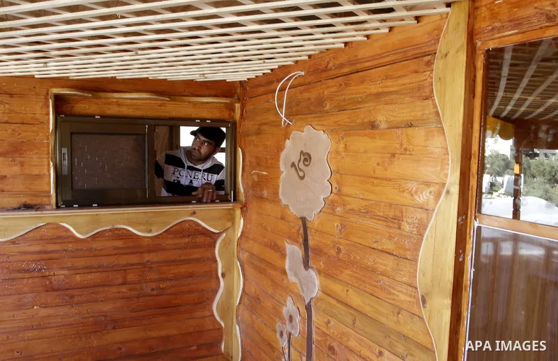 Palestinian carpenter Ibrahim Dokhan, 36, works using wood to rebuild a house, which was damaged during the recent Israeli offensive on Gaza Strip, in Rafah in the southern Gaza Strip, December 31, 2014. Because of the s...