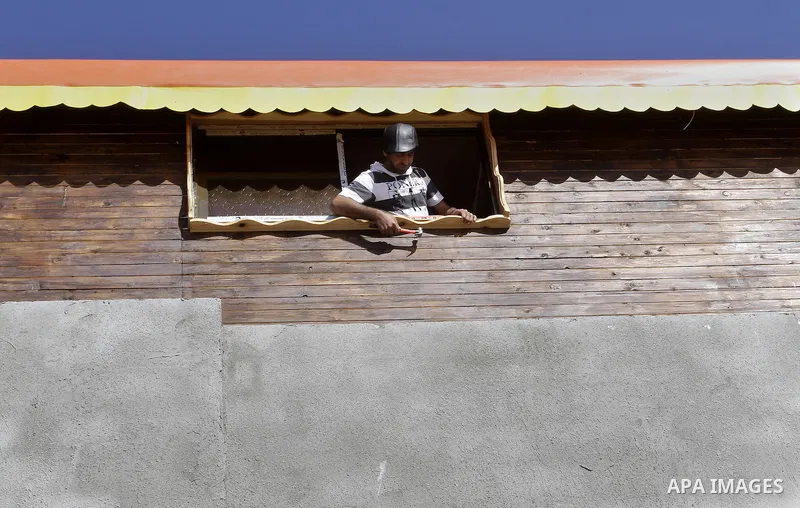 Palestinian carpenter Ibrahim Dokhan, 36, works using wood to rebuild a house, which was damaged during the recent Israeli offensive on Gaza Strip, in Rafah in the southern Gaza Strip, December 31, 2014. Because of the s...