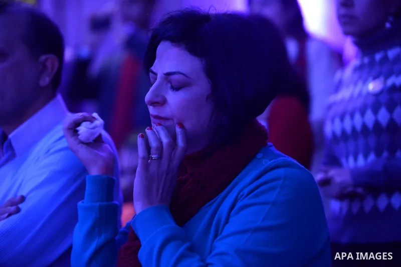 Egyptian Christians take part in a prayer during celebrations of Christmas and New Year festivities, at Kasr el-dobara evangelical Church, in Cairo on December 31, 2014. Photo by Amr Sayed