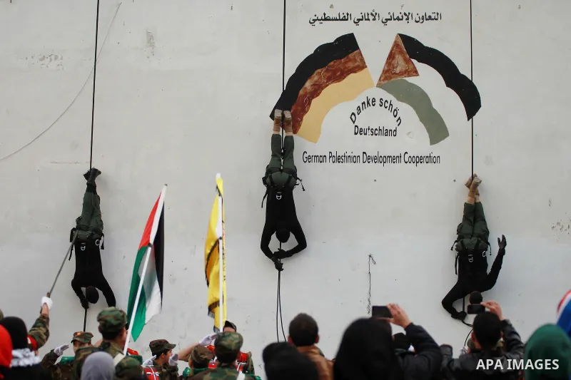 Members of Palestinian security forces show their skills during a military show to mark the 50th anniversary of the Fatah movement in the Qalandia refugee camp near the West Bank city of Ramallah, January 1, 2015. Yasser...