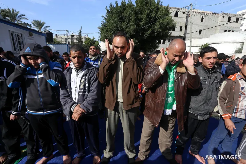 Palestinian supporters of Hamas movement attend Friday prayers in a protest demanding for the to launch of reconstruction of the territory devastated by a 50-day summer Israeli war, outside the headquarter of UNDP, in Ga...