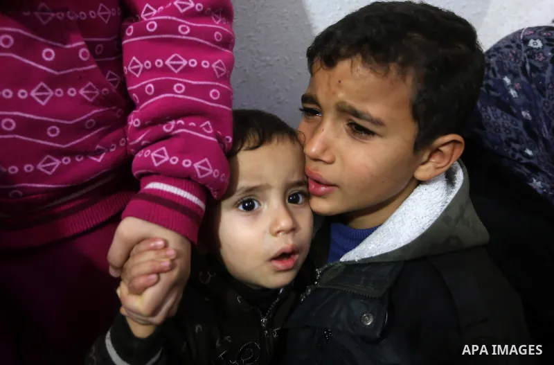 Relatives mourn during the funeral of two boys of EL-Habeel family who were dead when fire broke out due to an electrical malfunction in the backup power system, in al-Shatie refugee camp in Gaza City January 4, 2015. Pa...