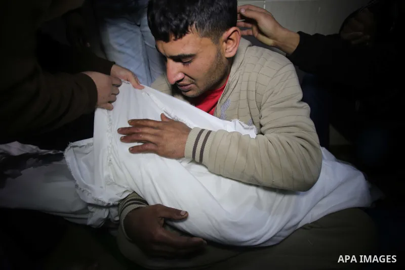 A relative carries the body of one of two boys of EL-Habeel family who were dead when fire broke out due to an electrical malfunction in the backup power system, during their funeral in al-Shatie refugee camp in Gaza Cit...