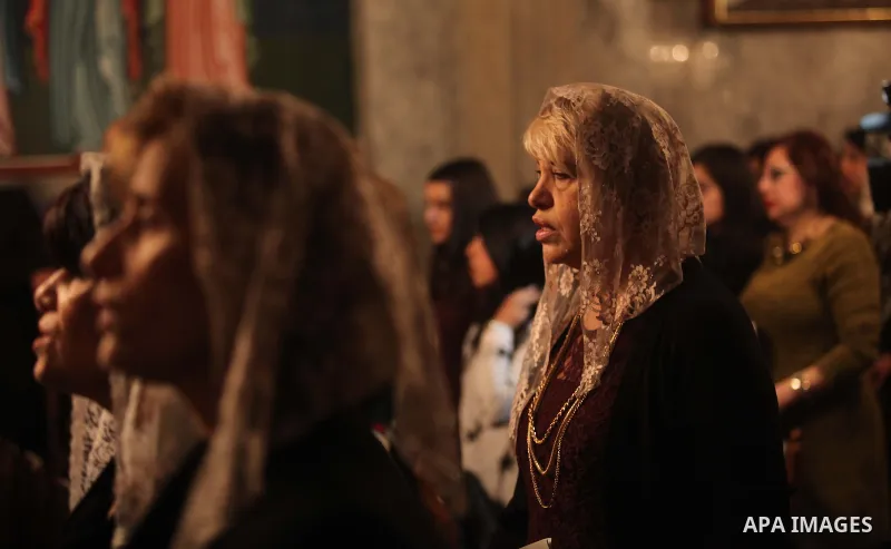 Palestinian Greek Orthodox Christians attend Christmas mass at the Orthodox Saint Porfirios church in Gaza City on January 7, 2015. The Orthodox Church celebrates Christmas and other religious holidays according to the J...