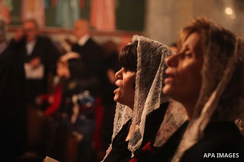 Palestinian Greek Orthodox Christians attend Christmas mass at the Orthodox Saint Porfirios church in Gaza City on January 7, 2015. The Orthodox Church celebrates Christmas and other religious holidays according to the J...