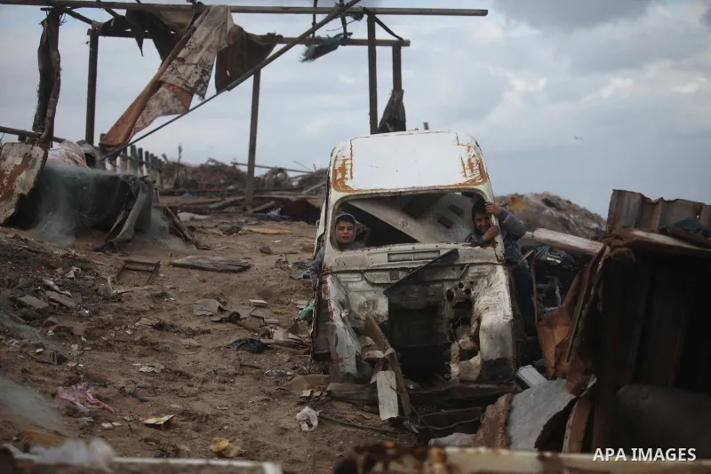 Palestinian children play in a car off the coast of Gaza Strip during a heavy winter storm, in Gaza city January 8, 2015. A storm buffeted the Middle East with blizzards, rain and strong winds on Wednesday, keeping peopl...