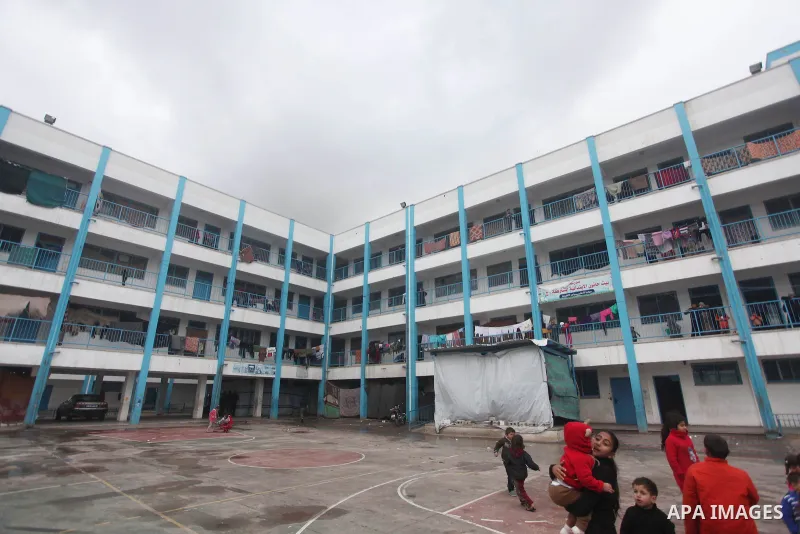 Palestinians children play at a United Nations (UN) run school sheltering Palestinians, whose houses were destroyed in the 50- day-war Israeli last summer, during a winter storm in Beit Hanoun in the northern Gaza Strip...