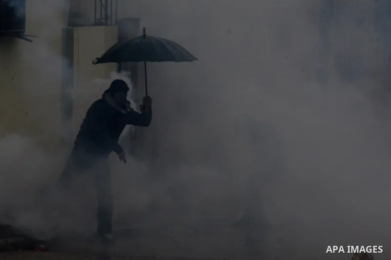 A Palestinian protestor throws a stone at Israeli security forces during clashes following a demonstration against the expropriation of Palestinian land by Israel in the West Bank village of Kfar Qaddum, near Nablus, on...