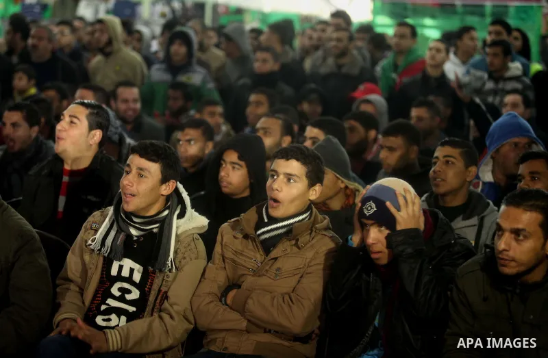 Palestinians football fans watch the match between Palestine and Japan in the AFC Asian Cup in Gaza city on January 12, 2015. Japan won the match with 4-0. Photo by Ashraf Amra