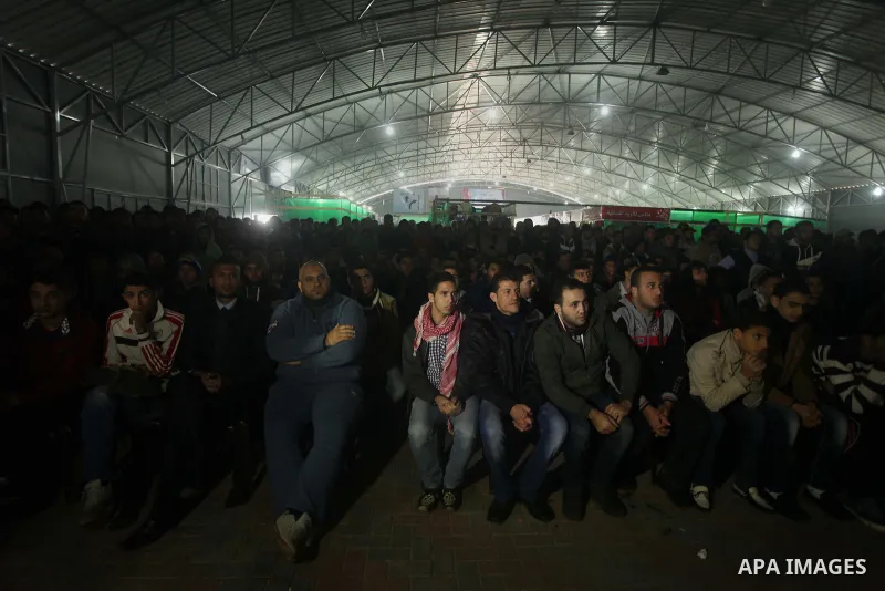 Palestinians football fans watch the match between Palestine and Japan in the AFC Asian Cup in Gaza city on January 12, 2015. Japan won the match with 4-0. Photo by Ashraf Amra