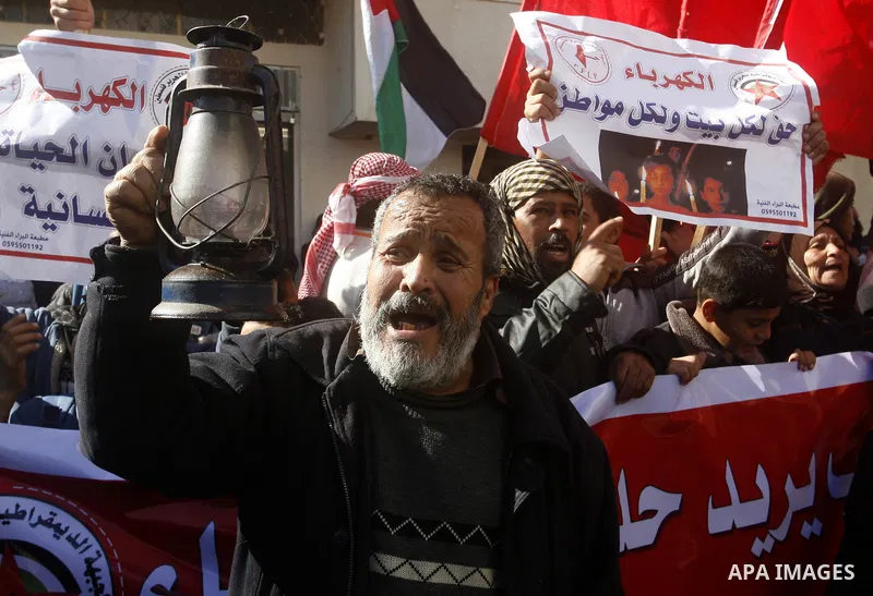 A Palestinian man holds a kerosene lamp during a protest against power crisis in Gaza, in Rafah in the southern Gaza Strip January 12, 2015. The protest was organized by Palestinian leftist parties. Palestinian Energy of...