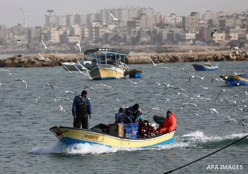 Palestinian fishermen ride their boat at the seaport near the coast of Gaza city, January 15, 2015. After seven years of Israeli blockade, 1.7 million Palestinians continue to be trapped in the Gaza Strip, largely cut of...