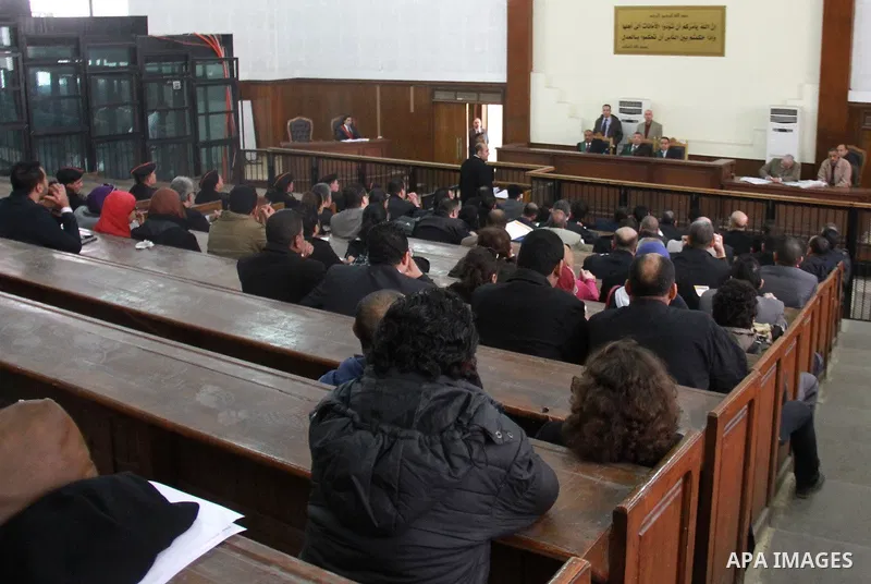 Judges attend the retrial of Alaa Abdel Fattah and 24 others, in the courtroom in Cairo on January 15, 2015. The defendants were sentenced in June to 15 years in prison for holding an unlicensed and violent protest outsi...
