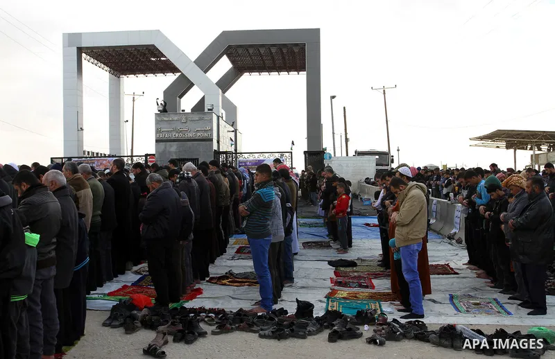 Palestinians perform Friday prayers at the Rafah border crossing between Egypt and southern Gaza Strip January 16, 2015, to demand that Egyptian authorities open the crossing. Egypt shut Rafah crossing, Gaza's main windo...