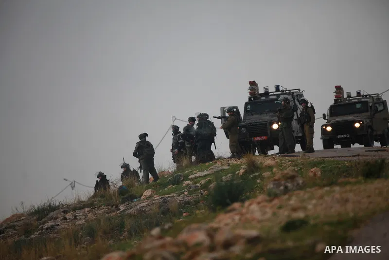 Israeli security forces take position during clashes with Palestinian protesters following a protest against the separation barrier (wall) and Jewish settlement construction at Bilin Village, near the West Bank city of o...