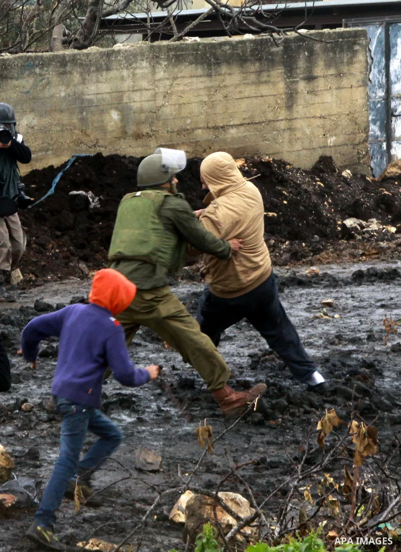 Israeli security forces detain a Palestinian protester during clashes following a protest against the expropriation of Palestinian land by Israel in the village of Kafr Qaddum, near the West Bank city of Nablus, January...