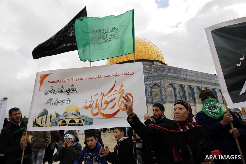 Palestinian protesters shout slogans in front of the Dome of the Rock during a demonstration against the printing of satirical sketches of the Prophet Mohammed by French magazine Charlie Hebdo, on the compound known to M...
