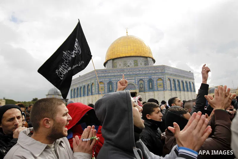 Palestinian protesters shout slogans in front of the Dome of the Rock during a demonstration against the printing of satirical sketches of the Prophet Mohammed by French magazine Charlie Hebdo, on the compound known to M...