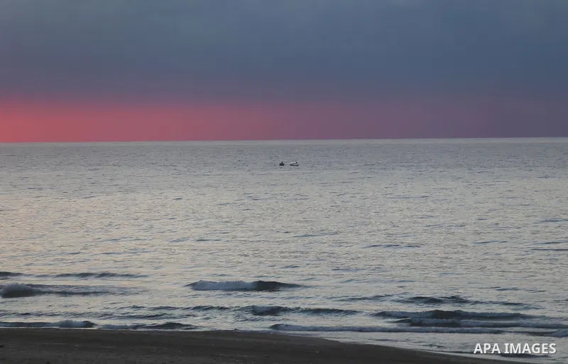 A Palestinian man rides his boat during sunset at the beach of Gaza city on January 17, 2015. Photo by Mohammed Asad