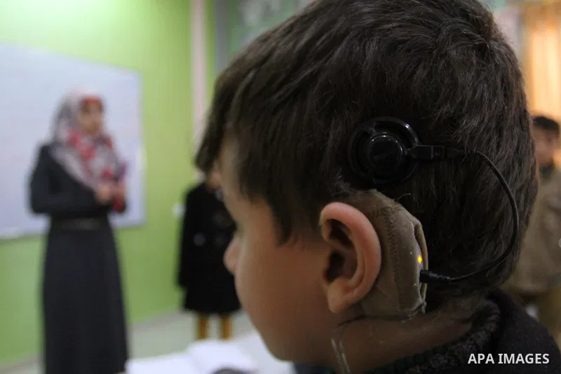 A deaf Palestinian boy looks on as he attends a classroom in a foundation for rehabilitation deaf children, in Khan Younis in the southern Gaza Strip, January 18, 2015. There are approximately 25,000 deaf and hearing imp...