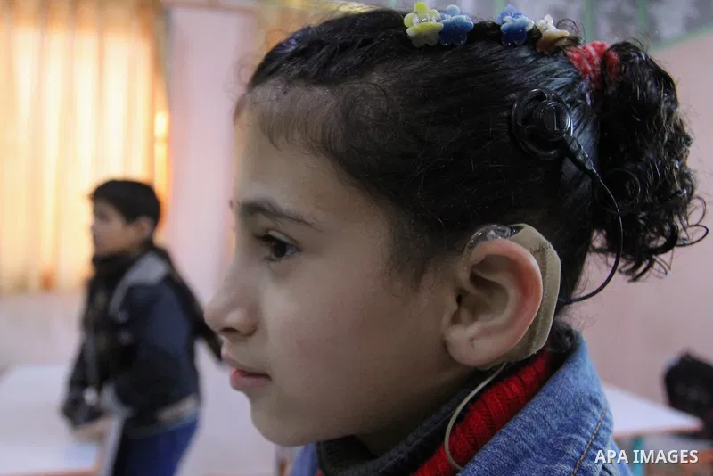 A deaf Palestinian girl looks on as she attends a classroom in a foundation for rehabilitation deaf children, in Khan Younis in the southern Gaza Strip, January 18, 2015. There are approximately 25,000 deaf and hearing i...