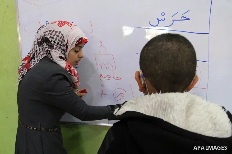 A Palestinian woman teaches a deaf boy in a foundation for rehabilitation deaf children, in Khan Younis in the southern Gaza Strip, January 18, 2015. There are approximately 25,000 deaf and hearing impaired people in the...