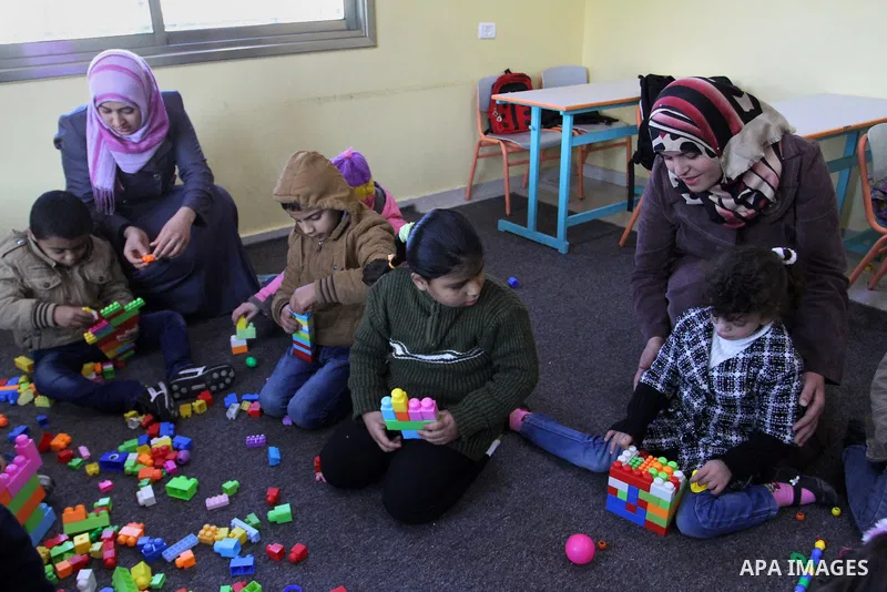 Deaf Palestinian children play in a foundation for rehabilitation deaf children, in Khan Younis in the southern Gaza Strip, January 18, 2015. There are approximately 25,000 deaf and hearing impaired people in the Gaza St...