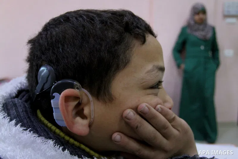 A deaf Palestinian boy looks on as he attends a classroom in a foundation for rehabilitation deaf children, in Khan Younis in the southern Gaza Strip, January 18, 2015. There are approximately 25,000 deaf and hearing imp...