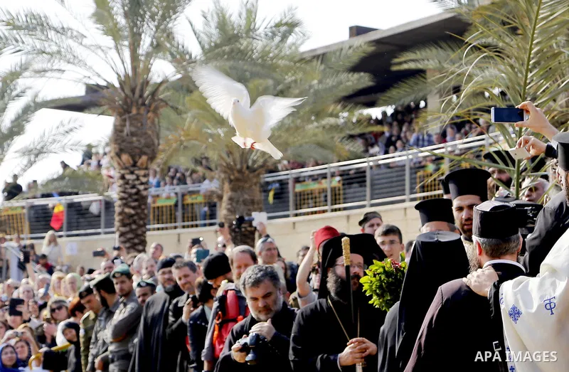 Christians pilgrims take part in a ceremony at the baptismal site known as Qasr el-Yahud on the banks of the Jordan River near the West Bank city of Jericho January 18, 2015. Orthodox Christians flocked to the Jordan Riv...