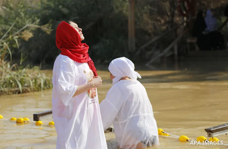 Christian pilgrims dip in the water after a ceremony at the baptismal site known as Qasr el-Yahud on the banks of the Jordan River near the West Bank city of Jericho January 18, 2015. Orthodox Christians flocked to the J...