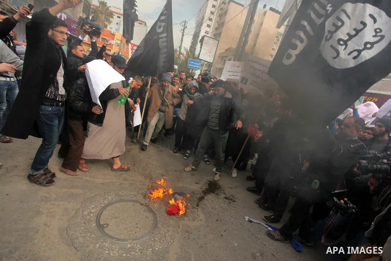 Palestinian Salafists burn a French national flag during a protest against the satirical French weekly magazine Charlie Hebdo's cartoons of the Prophet Mohammad, in Gaza city January 19, 2015. Dozens of Jihadist Salafi m...