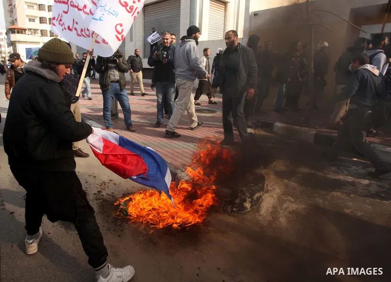 Palestinian Salafists burn French flag during in a protest against satirical French weekly magazine Charlie Hebdo's cartoons of the Prophet Mohammad, outside the French Cultural Centre in Gaza city January 19, 2015. Doze...