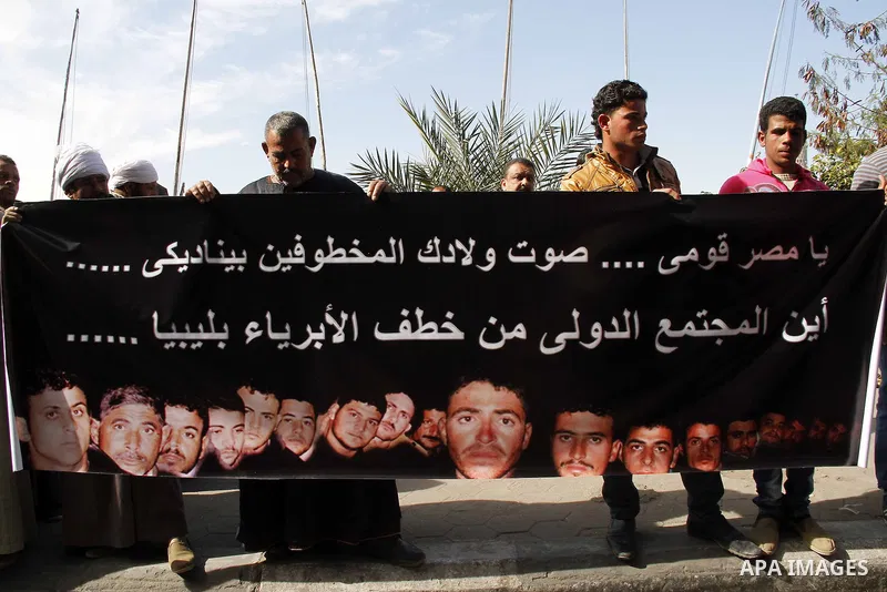 Relatives of kidnapped Egyptian in Libya, hold their pictures during a protest outside the United Nations headquarters, in Cairo on January 19, 2015. Thirteen Egyptians were kidnapped in the Libyan city of Sirte, adding...